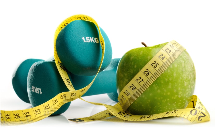 Weights, apple and a measuring tape